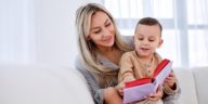 woman holding a child and reading a book