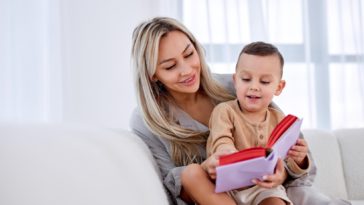 woman holding a child and reading a book