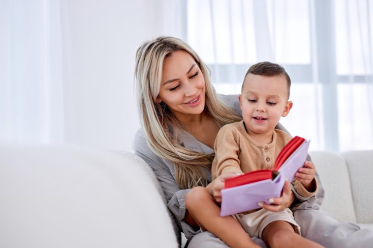 woman holding a child and reading a book