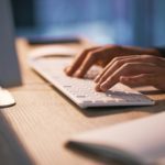 hands typing on a keyboard