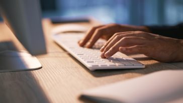 hands typing on a keyboard