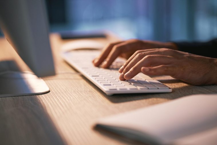 hands typing on a keyboard