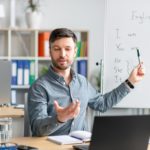 man giving remote English language lessons via a laptop