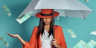 woman holding an umbrella being showered by cash