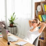 woman working at a desk with a laptop at home