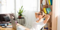 woman working at a desk with a laptop at home