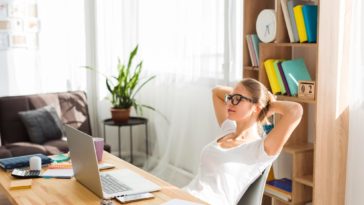 woman working at a desk with a laptop at home