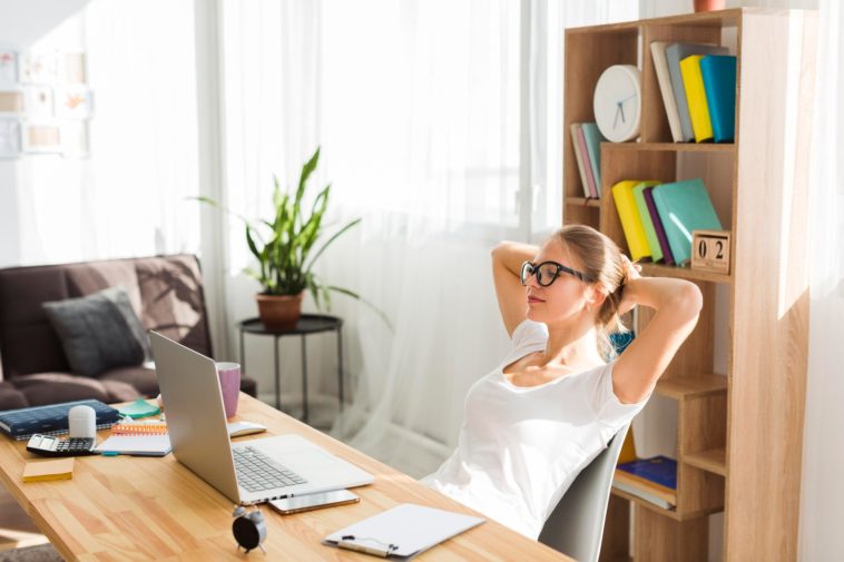 woman working at a desk with a laptop at home