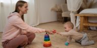 smiling woman playing with a small child