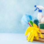 a wooden box with cleaning products with a blue background