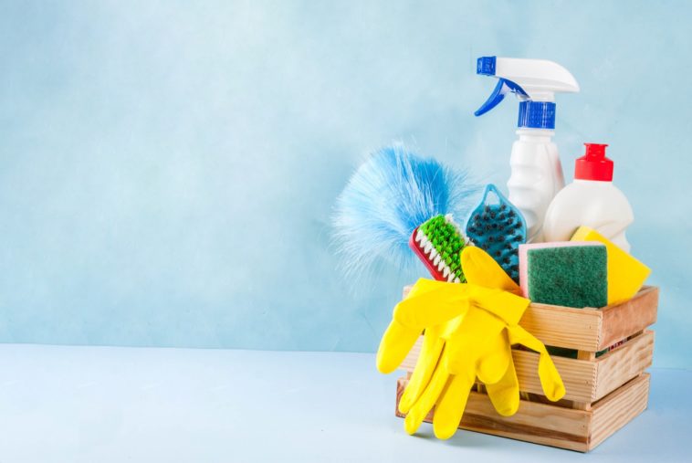 a wooden box with cleaning products with a blue background