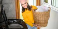 woman doing laundry using a home washing machine
