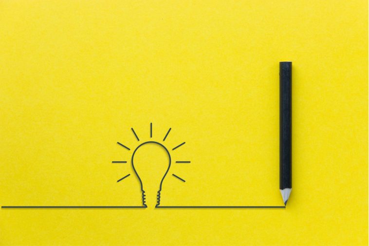 drawing of a light bulb and a black pencil with a yellow background