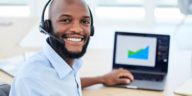 sales representative wearing a headset working on a laptop