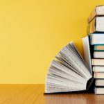 pile of book with a yellow background