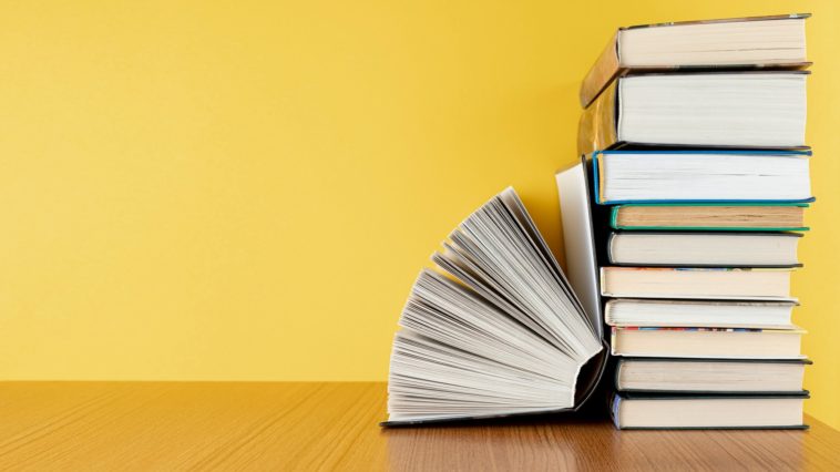 pile of book with a yellow background