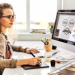 woman working on designing logos on a computer