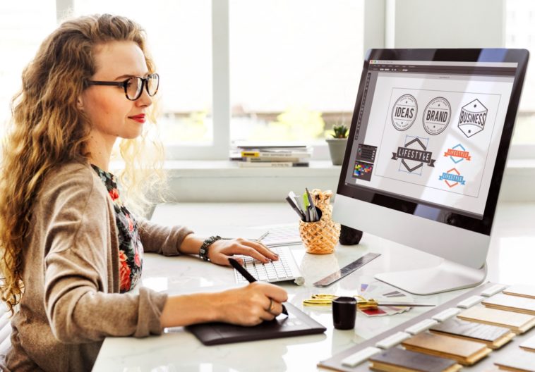 woman working on designing logos on a computer