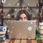 woman showing only her eyes looking out her laptop