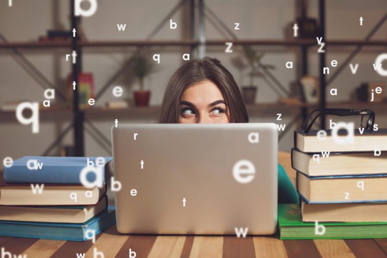 woman showing only her eyes looking out her laptop