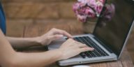 woman hands typing on a laptop