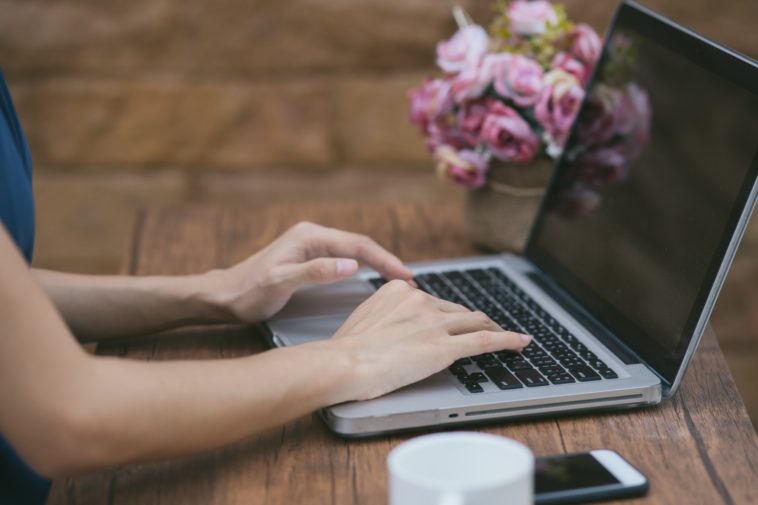 woman hands typing on a laptop