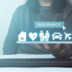woman holding a tablet with 3d insurance icons above it