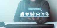 woman holding a tablet with 3d insurance icons above it