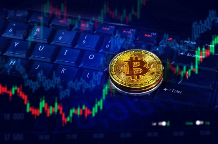 bitcoin trading graph chart over a keyboard