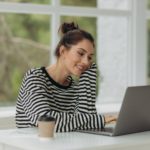 young girl using a laptop at home