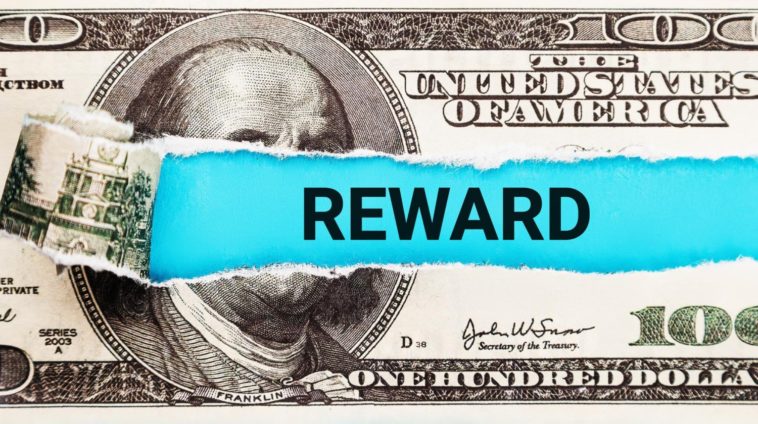 hundred dollar bill with reward written in the middle