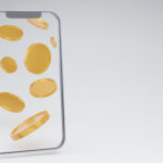 smartphone blank display with gold coins falling on a white background