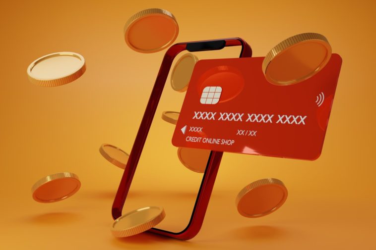 smartphone blank display with a credit card and gold coins around it