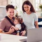 family with baby looking at a laptop screen