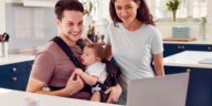 family with baby looking at a laptop screen