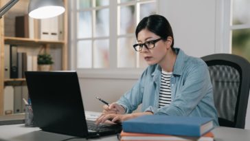 woman sitting at a desk working on a laptop