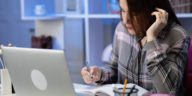 woman sitting at a desk wearing headphones