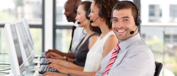 people with headphones working on computers