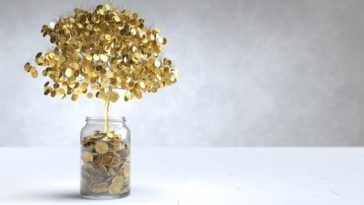 tree made of gold coins growing out of a jar of coins