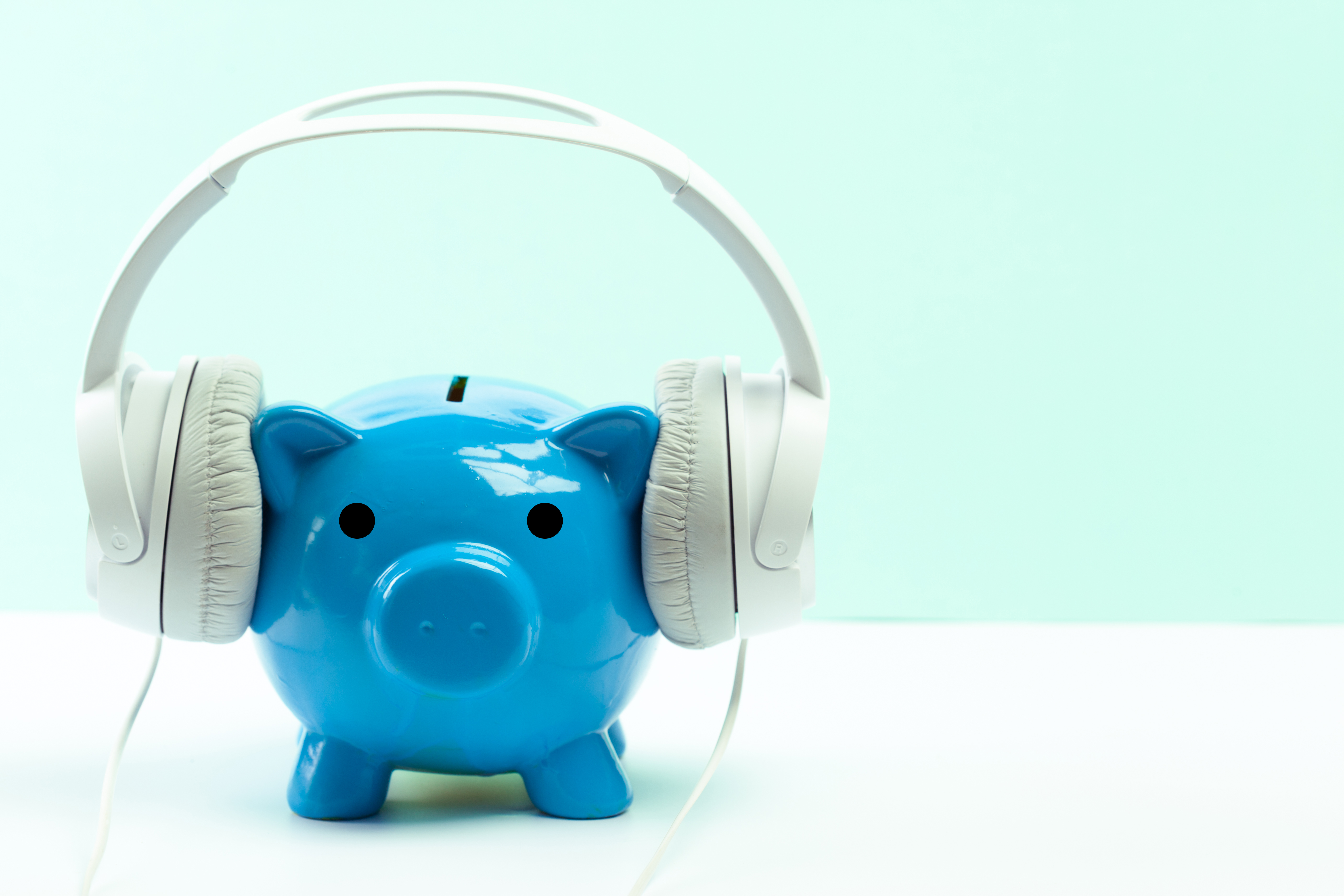 blue piggy bank with white headphones