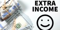 dollar bills next to an extra income and smiley face drawing in black