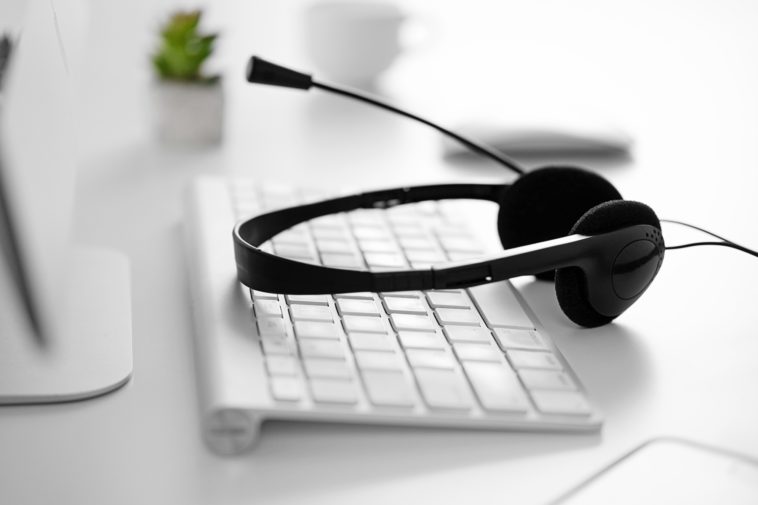 black headset on a white computer keyboard