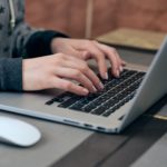 woman hands typing on a laptop