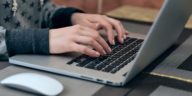 woman hands typing on a laptop