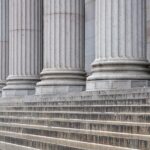 row of white stone pillars and classical stairs