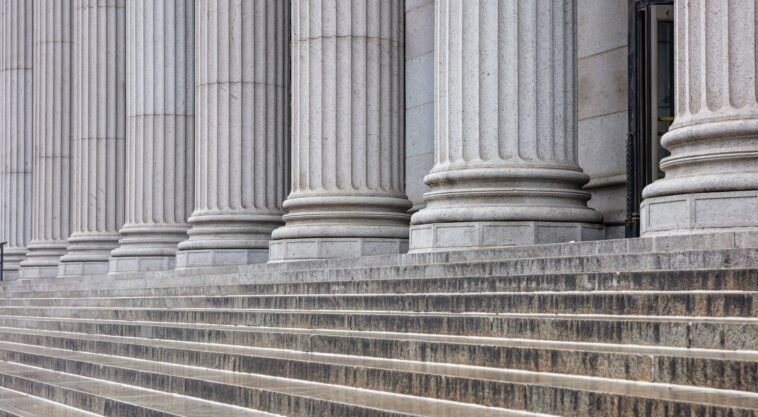 row of white stone pillars and classical stairs