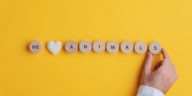 we love animals written on wooden blocks with a yellow background
