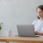 woman in a home office working on a laptop