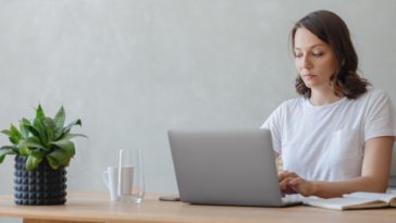 woman in a home office working on a laptop