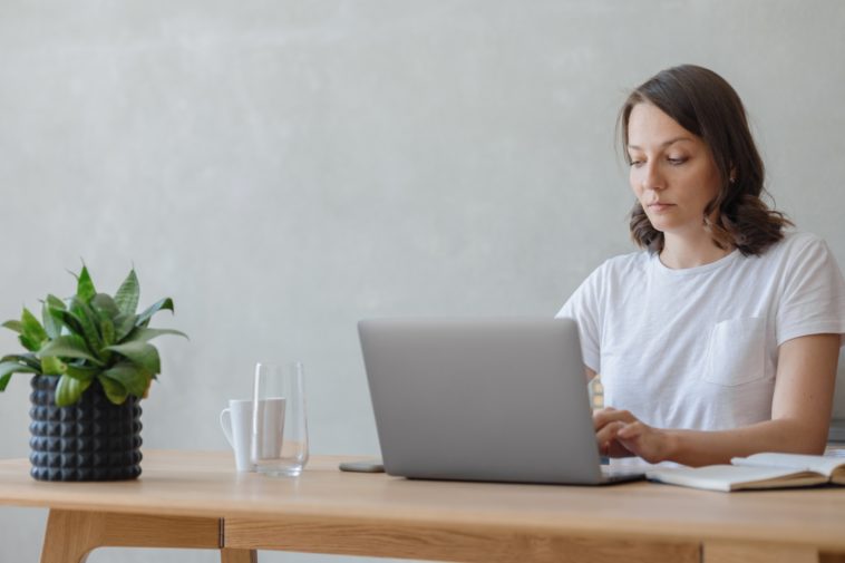 woman in a home office working on a laptop